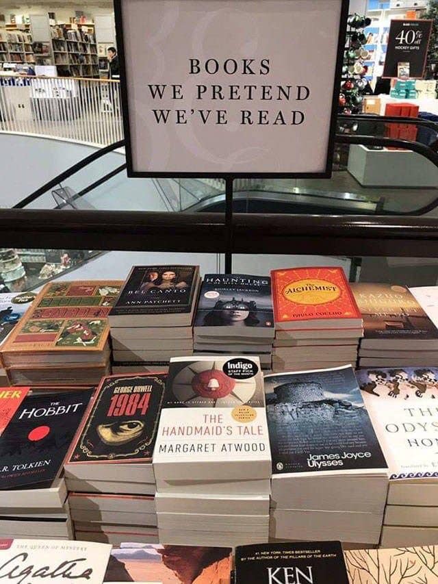 bookstore table with humorous sign saying, "Books We Pretend We've Read"