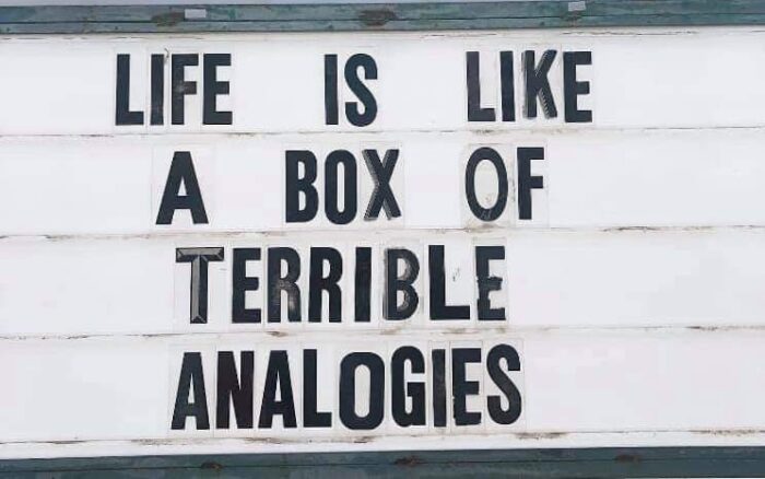 Sign: "LIFE IS LIKE A BOX OF TERRIBLE ANALOGIES"