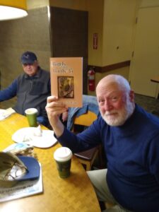 Steve Glines holding up copy of Bagels With the Bards Vol. 15
