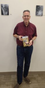 Phil Temples posed with his new book "Down On The Farm: Spacey Tails From Flyover Country"